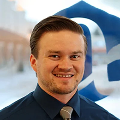 Chiropractor Caleb Blank In Dress Shirt Smiling